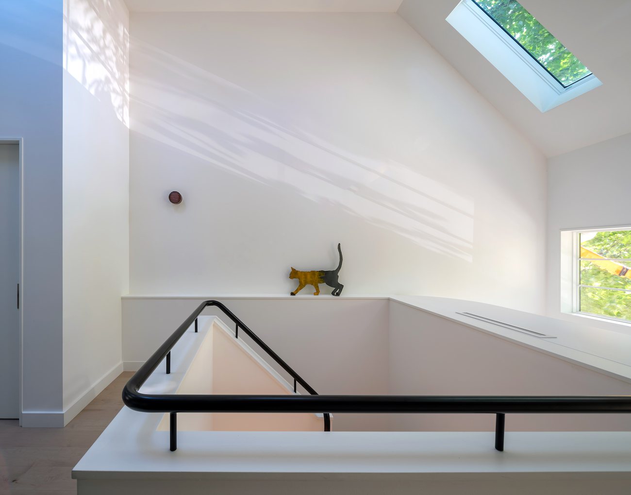 A bright, open stairway with natural light falling across a clean modern interior